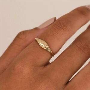 Detail of gold star-embossed S925 silver ring with zircon stones on model finger