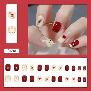 Detail view of R698 cute bunny and strawberry press-on nails set in caramel and cream