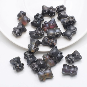 Macro detail of iridescent dark grey bear-shaped crystal beads for DIY jewelry making