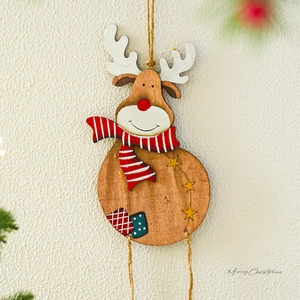 Wooden reindeer Christmas ornament with red scarf hanging on a textured wall background