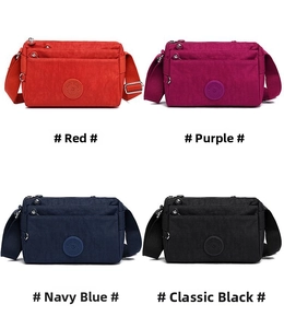Detail view of multi-pocket nylon crossbody bags in red, purple, blue, and black