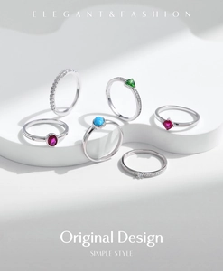 Macro view of S925 silver rings with heart-shaped ruby and emerald gemstones