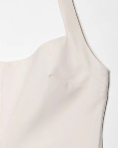 Close-up of beige halter neck strap and stitching detail on a slim-fit summer dress