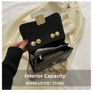 Detail of black quilted chain bag interior with golden square lock and daily essentials