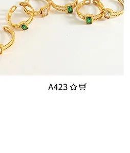 Detail of a vintage-style open ring with emerald gemstone and twisted rope band