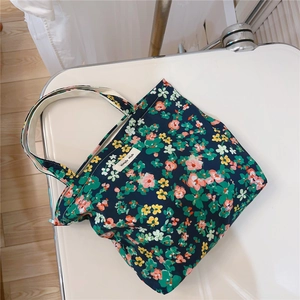 Detail of blue floral cotton tote bag with handle and simple wish brand label
