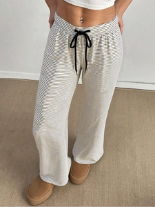 Detailed view of striped wide-leg pants featuring a black drawstring waist and soft knit fabric