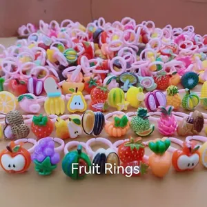 Pink cartoon plastic fruit rings for girls including strawberry and watermelon shapes
