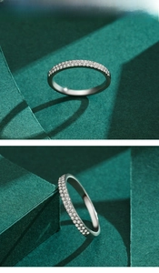 Macro detail of s925 silver double row pavé diamond ring on a minimalist green pedestal