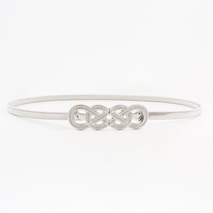 Macro detail of silver elastic metal waist chain with textured infinity buckle design
