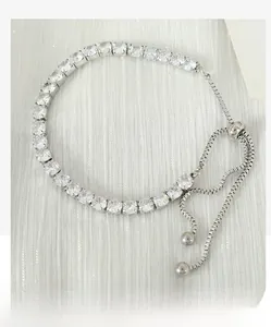 Macro detail of silver-tone zircon bracelet with adjustable slider and claw-set stones