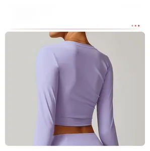 Detail of lilac long sleeve yoga top featuring slim fit back design and four-way stretch
