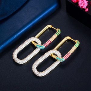 Macro detail of gold interlocking earrings with multi-colored micro-pave cubic zirconia