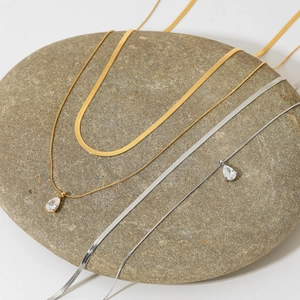 Double-layered snake chain necklaces with zircon pendants in gold and silver finish