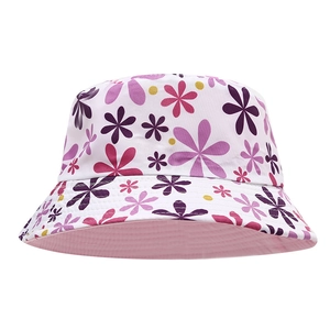 Detailed close-up of white floral bucket hat showing cotton texture and colorful prints