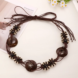 Detail of bohemian waist chain with brown braided ropes, wood beads, and coconut shell rings