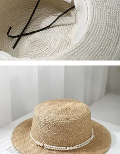 Detail of adjustable inner drawstring and pearl chain on a flat top straw sun hat