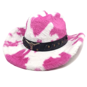 Detail of pink cow print plush cowboy hat with a silver bull head metal emblem and leather band