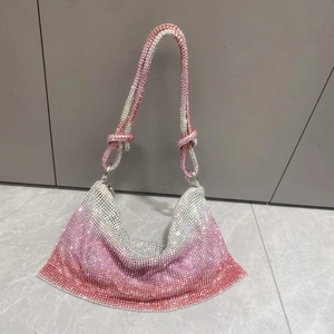 Detail view of pink gradient rhinestone handbag with a stylish knotted top handle design