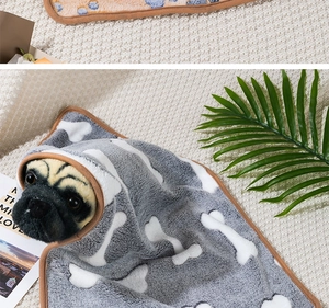 Detail of grey pet blanket with bone print used as a warm head wrap for small pets