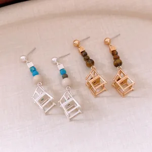 Elegant chair pendant earrings with silver needle pearls and matte beads in gold and silver