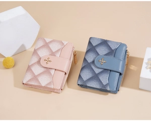 Detail of pink and blue quilted wallets with cross clasp and gold zipper accents