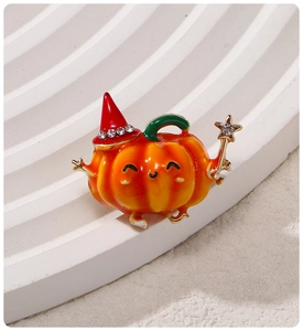 Detailed view of Halloween pumpkin brooch with red rhinestone hat and gold magic wand