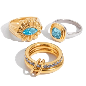 Titanium steel ring set with blue zircon featuring flower and geometric designs in gold and silver