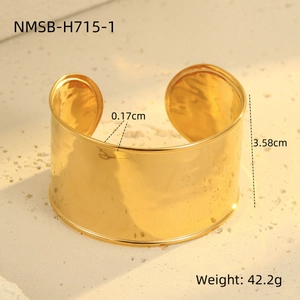 Macro view of wide gold titanium steel cuff bracelet with precise height and thickness details