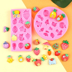 Close-up of pink silicone fruit molds with strawberry and pineapple shapes for DIY baking