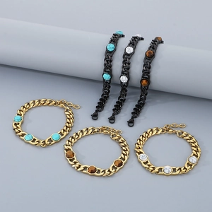 Detailed view of gold and black Cuban chains inlaid with turquoise and tiger eye stones