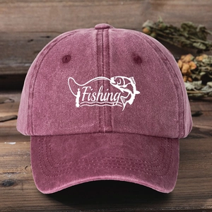 Vintage burgundy washed cotton baseball cap with Fishing embroidery on a rustic wooden table