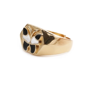 Detail view of a gold-plated butterfly ring featuring black and white enamel finish