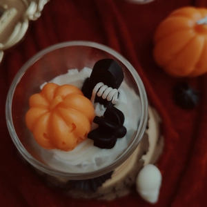 Top view of Halloween scented candle with 3D pumpkin, spider, and skull wax carvings