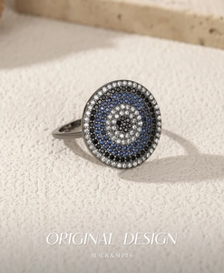 Macro shot of S925 silver evil eye ring with blue and white pavé cubic zirconia