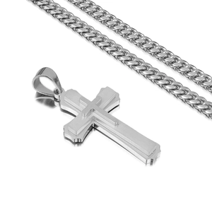 Detailed view of silver triple-layered cross pendant with cuban chain on white background