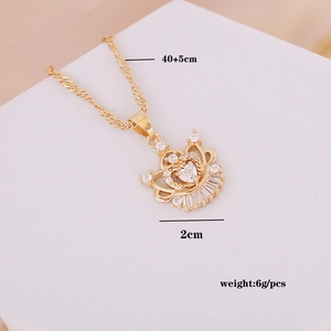 Detailed view of gold crown pendant necklace with zircon inlay and product dimensions
