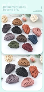 Detailed view of leaf-shaped matte hair claws in various Morandi colors with vein textures