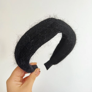 Detail of black faux fur headband featuring a stylish twist knot and plush texture