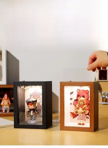 Detail view of display boxes with warm built-in lighting and acrylic panels for figures