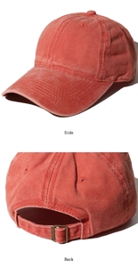 Detail view of vintage red washed cotton baseball cap with adjustable metal back buckle