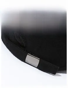 Macro detail of the adjustable metal buckle and black fabric on the winter baseball cap