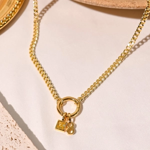 Detail of 18K gold plated Cuban chain necklace with number 8 and yellow gem pendant