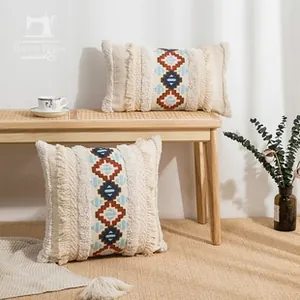 Detail of bohemian embroidery and fringe tassel edge on beige cotton linen pillow covers