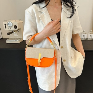 Fashionable orange and beige patchwork crossbody bag with gold hardware and strap