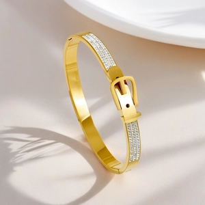 Detailed view of gold plated titanium steel bangle with belt buckle and zirconia stones