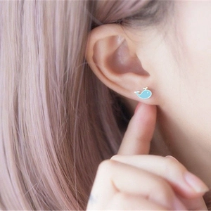 S925 sterling silver blue whale stud earrings with enamel finish on a model's ear