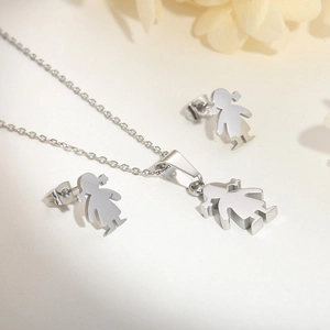 Detailed view of silver stainless steel girl silhouette necklace and earrings jewelry set