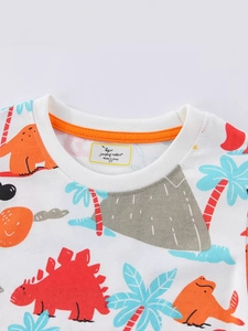 Close-up of white boys' short-sleeved T-shirt with vibrant cartoon dinosaur prints