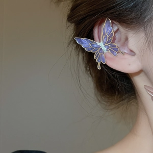 Detail of purple butterfly ear cuff with gold frame worn on a model's ear